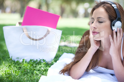 Graceful women listening music with hand bag