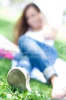 Blur image of a Young women lying in the park