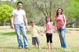 Family posing to camera in the park