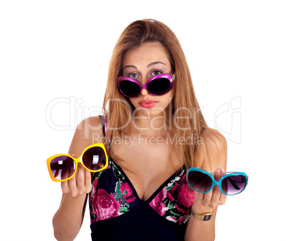 Young woman holding different colors of sunglasses