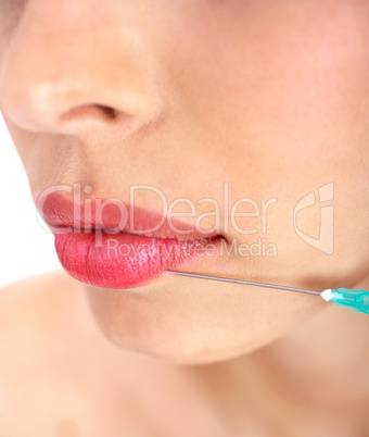 Doctor giving injection on face of a young woman on her upper lip