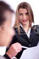 Cheerful young business woman in her meeting with her collegue