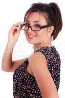 Young pretty woman in side pose looking at you  over her glasses