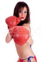 Young Woman in red bikini doing boxing excercise with red gloves