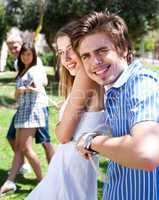 young  couples playing tug of war game and having fun
