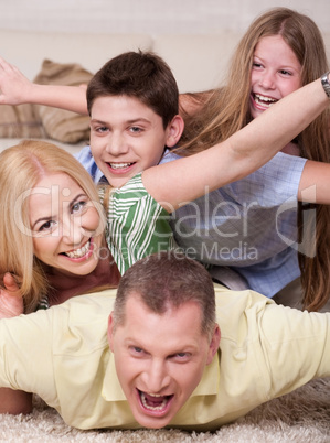 Happy family Lying On Top Of Each Other