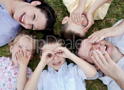 Happy family lying in the ground