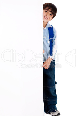 Young kid standing behind the board