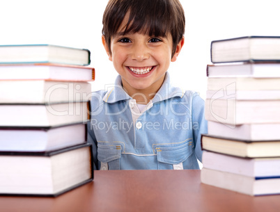 School boy surrounded by books