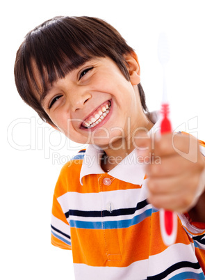 Happy young boy showing the toothbrush