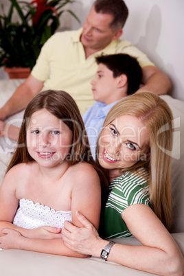 Family of four relaxing at home