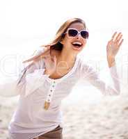 Happy young woman having fun at the beach