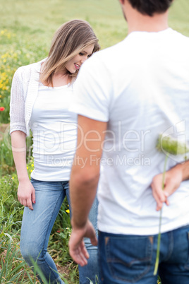 Rear view of a boyfriend hiding a flower