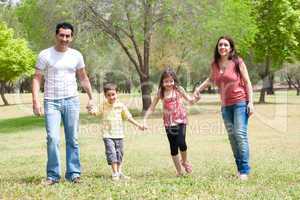 Family posing to camera in the park