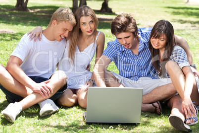 Young boys and girl students using laptop