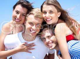 Two Young man giving piggyback to their girlfriends