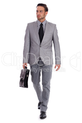 Businessman carrying briefcase and walking