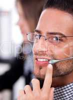 business man speaking through head phone