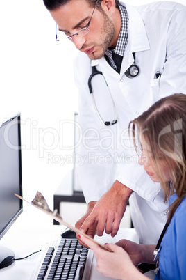Two busy doctors discussing with the medical reports