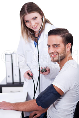 Female doctor checking blood pressure