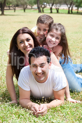 Happy family lying in the grass field