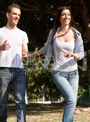 Young couple running in the prak