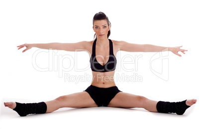 Woman doing gymastic exercise on floor
