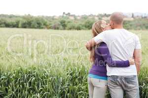 Rear view of couple, girl kissing the male