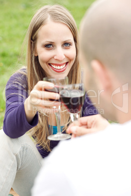 Young romantic couple celebrating with wine