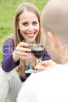 Young romantic couple celebrating with wine