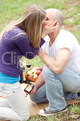 Happy woman kissing her boyfriend for the precious gift