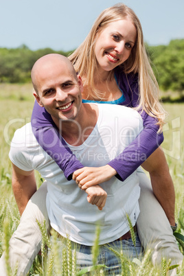 Two young lovers holding each other piggyback