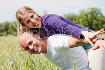 Happy couple enjoying with their arms outstreched
