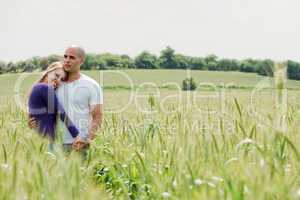 Shot of young couple hugging and holding hands