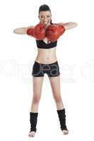 Female boxer looking very focused with red gloves