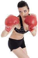 Sporty girl in boxing gloves punching