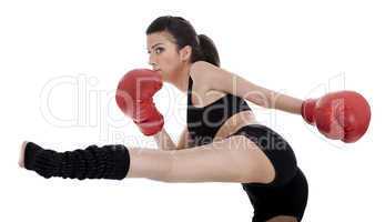 Kickboxing girl giving strong kick with her leg