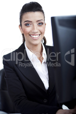 Closeup of young business woman infront of the computer