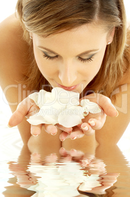 smelling rose petals in water