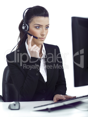 Busy woman seriously hearing the customer talk in headset