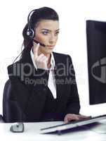 Busy woman seriously hearing the customer talk in headset