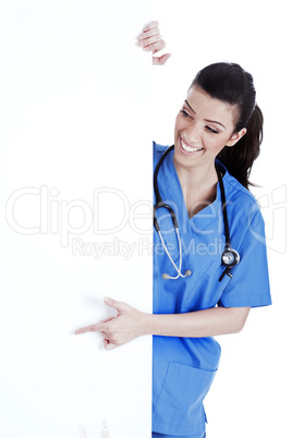 Portrait of female nurse standing behind the white board
