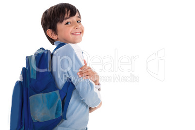 Happy young boy ready for school with his bag