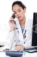 Beautiful female doctor trying the phone very seriously