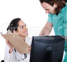 Doctor explains patient record to the male nurse