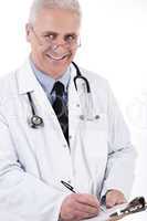 Smiling medical doctor writing prescription
