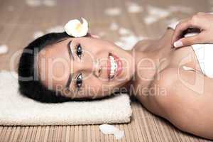 bautiful smiling woman lying down for spa treatment