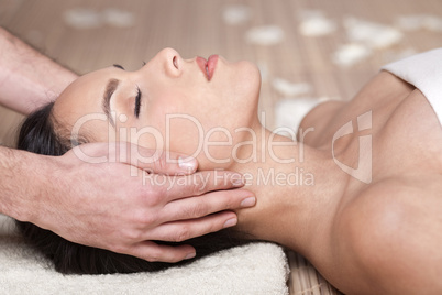 Happy woman receiving head massage