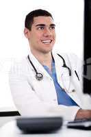 Smiling young doctor at his office