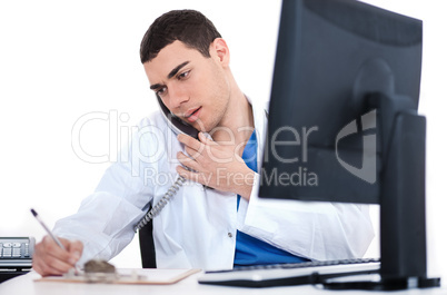 Doctor making notes of the conversation over phone